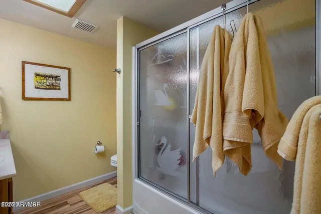 a bathroom with a glass shower door