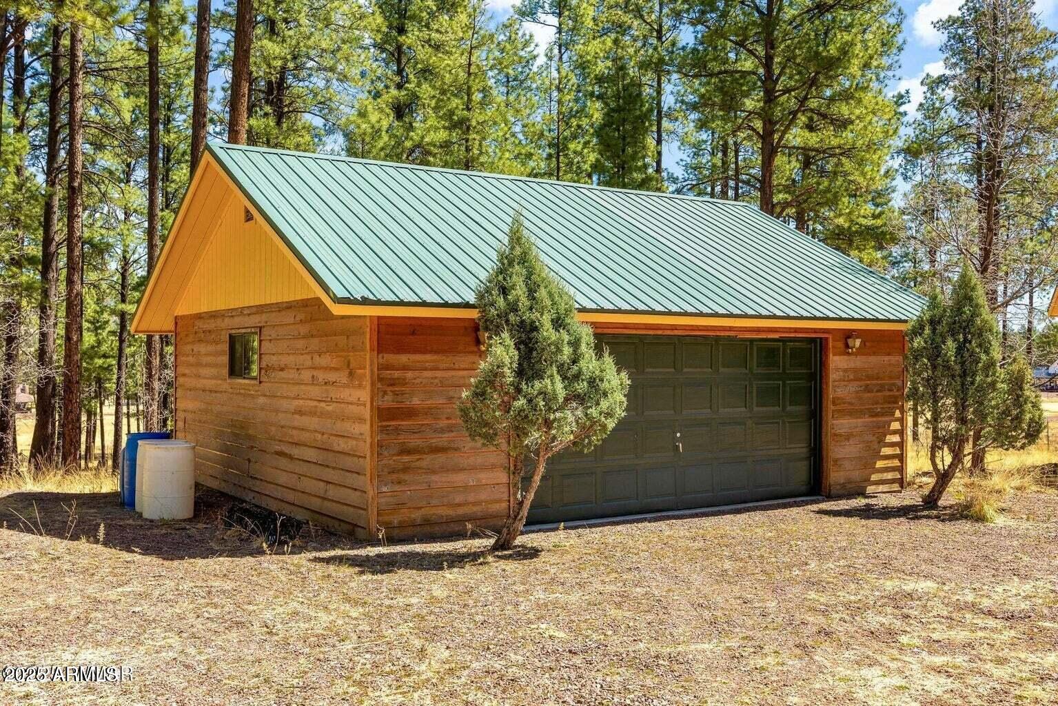 61 County Road 2266 Alpine, AZ 85920 - Photo 37 of 51 a front view of a house with a yard and garage