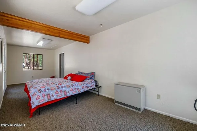 a bedroom with a bed and window