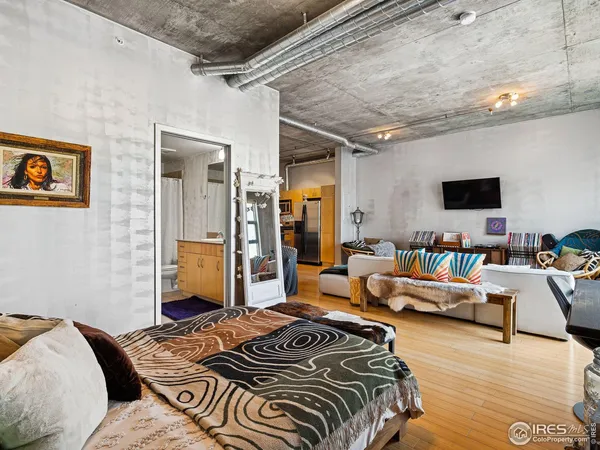 a bedroom with furniture and a flat screen tv