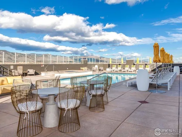 a view of a swimming pool and outdoor seating