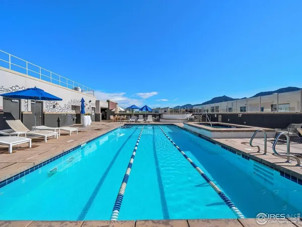a swimming pool view with a seating space