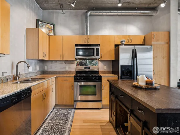 a kitchen with stainless steel appliances granite countertop a stove and a sink