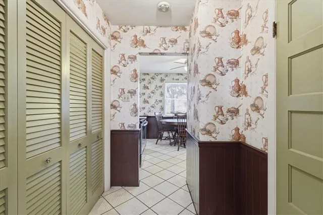 a view of a hallway with dining area and front door