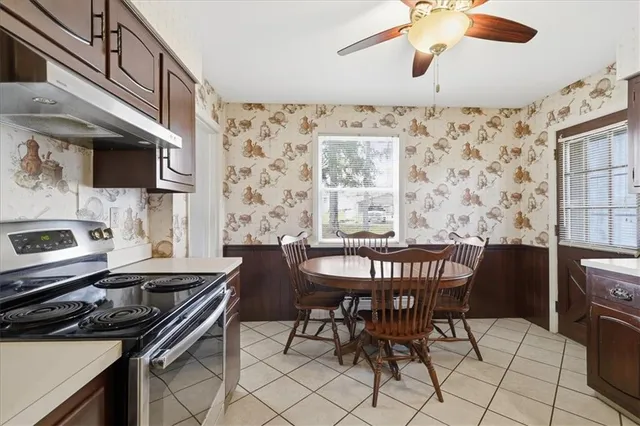 a kitchen with a dining table and chairs