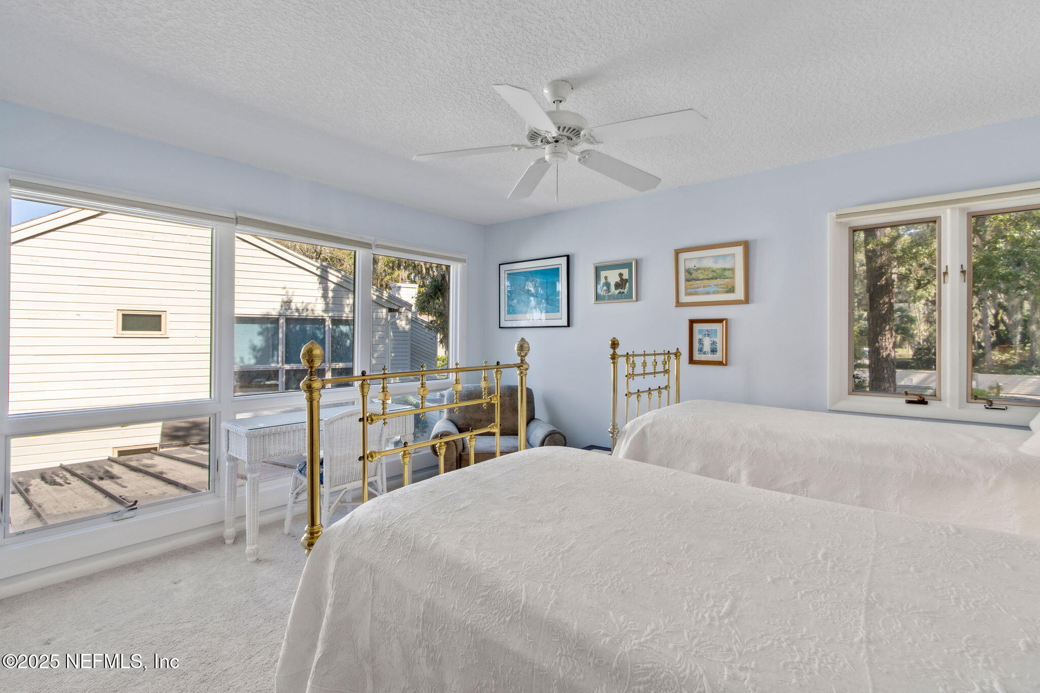 3417 Sea Marsh Road Fernandina Beach, FL 32034 - Photo 16 of 19 a bedroom with a large bed and a large window