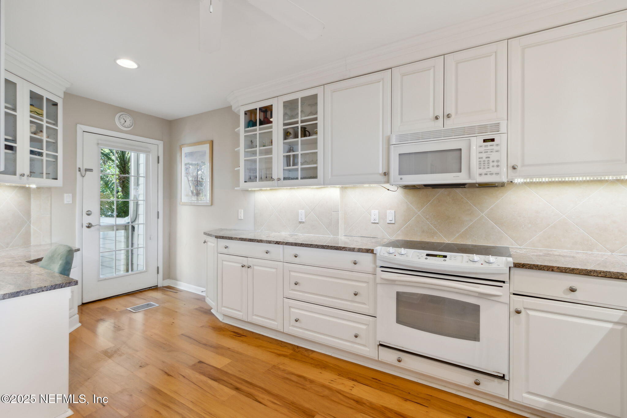 3417 Sea Marsh Road Fernandina Beach, FL 32034 - Photo 8 of 19 a kitchen with granite countertop white cabinets and white appliances