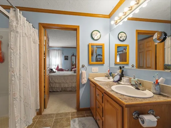 a bathroom with a sink a toilet and a mirror