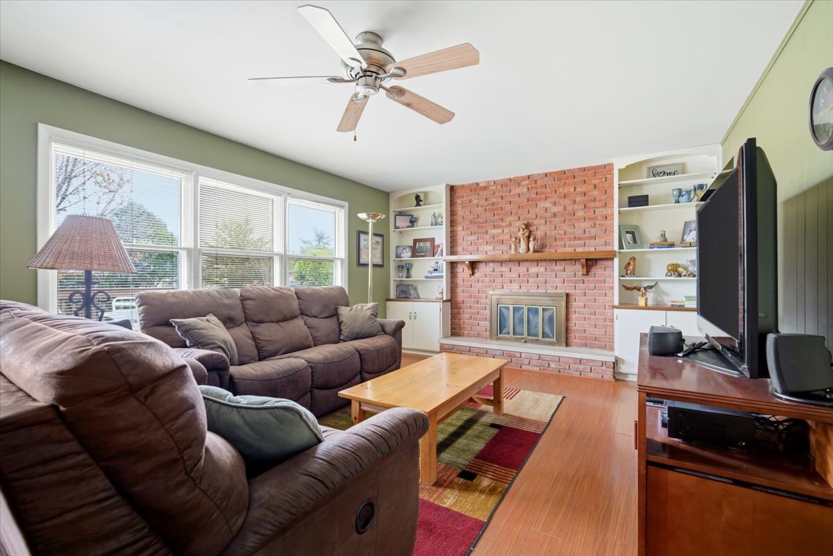 1204 Westview Drive Normal, IL 61761 - Photo 11 of 25 a living room with furniture a fireplace and a flat screen tv