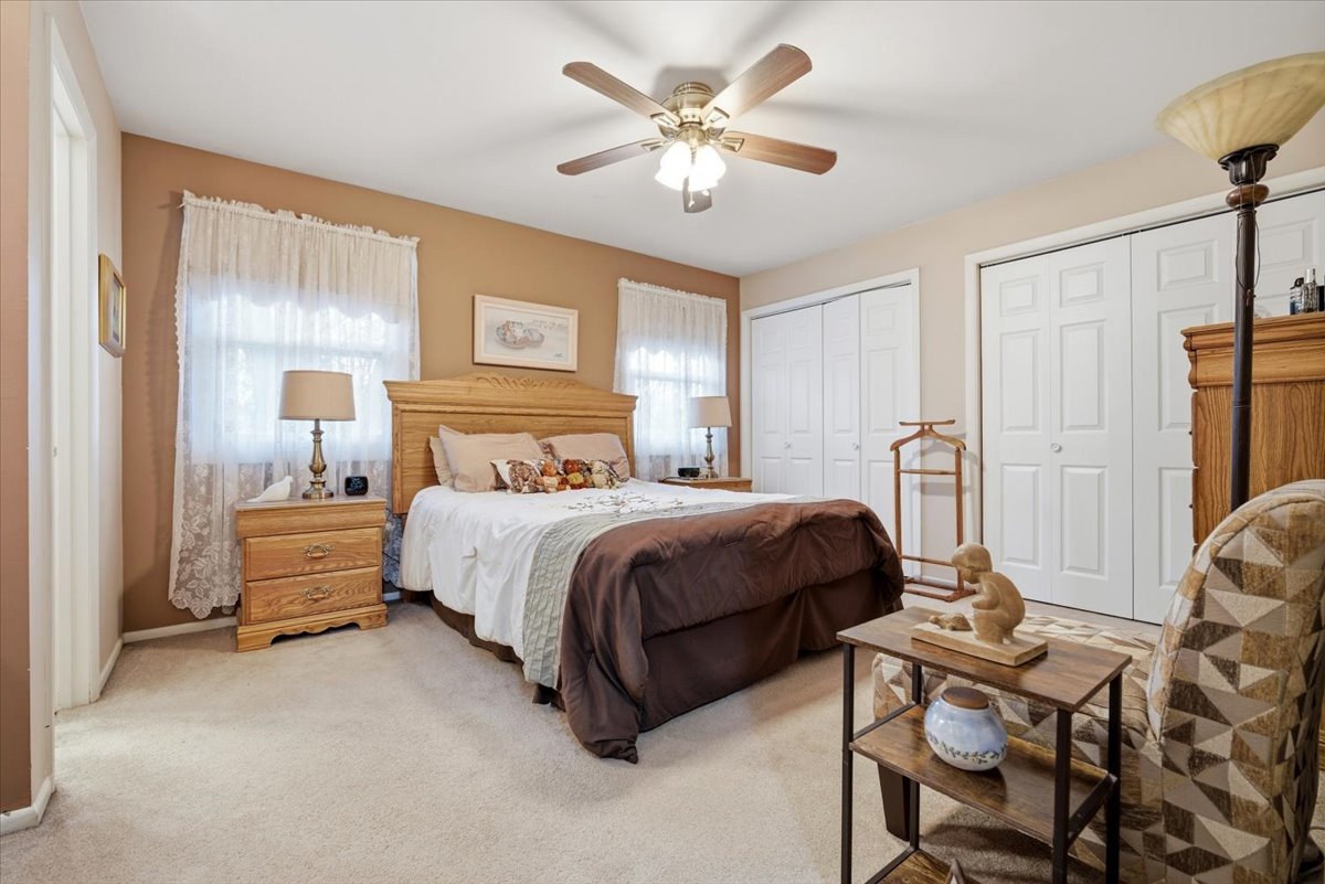 1204 Westview Drive Normal, IL 61761 - Photo 14 of 25 a spacious bedroom with a bed and a chandelier