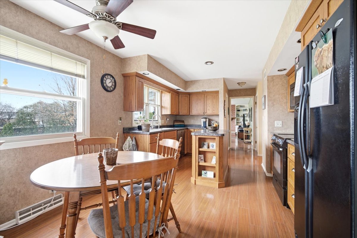 1204 Westview Drive Normal, IL 61761 - Photo 7 of 25 a view of a dining room with furniture window and wooden floor