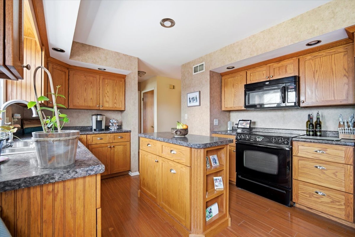 1204 Westview Drive Normal, IL 61761 - Photo 9 of 25 a kitchen with stainless steel appliances granite countertop a sink stove and cabinets