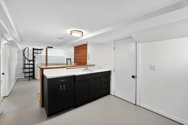 a kitchen with granite countertop a sink and cabinets