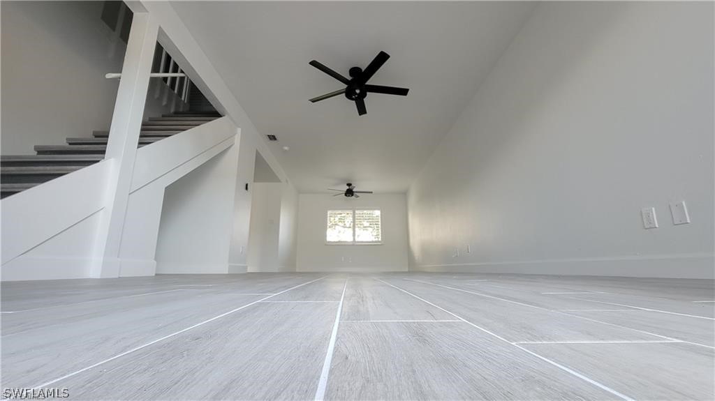 a view of a ceiling fan and wooden floor