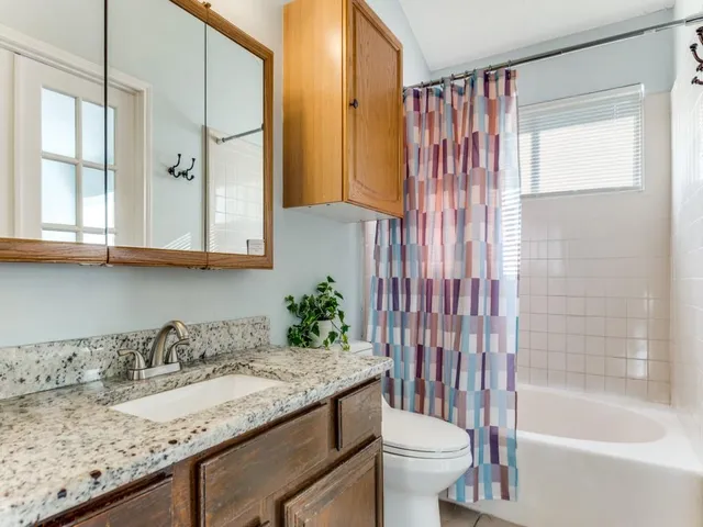 a bedroom with a dresser and a mirror