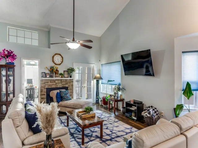 a living room with furniture a fireplace and a flat screen tv
