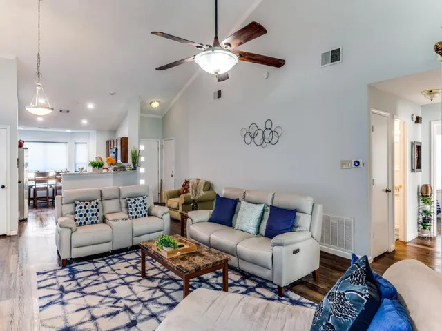 a living room with furniture and a chandelier