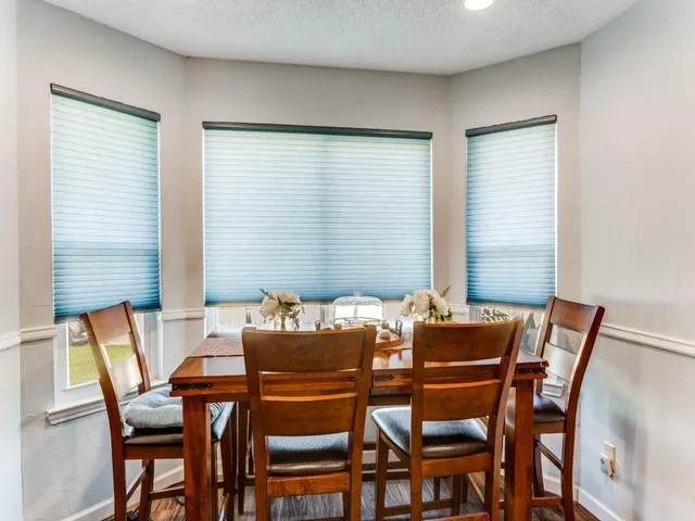 a dining room with furniture and window