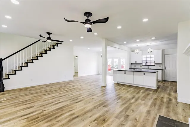 a view of an empty room with a fireplace and a window