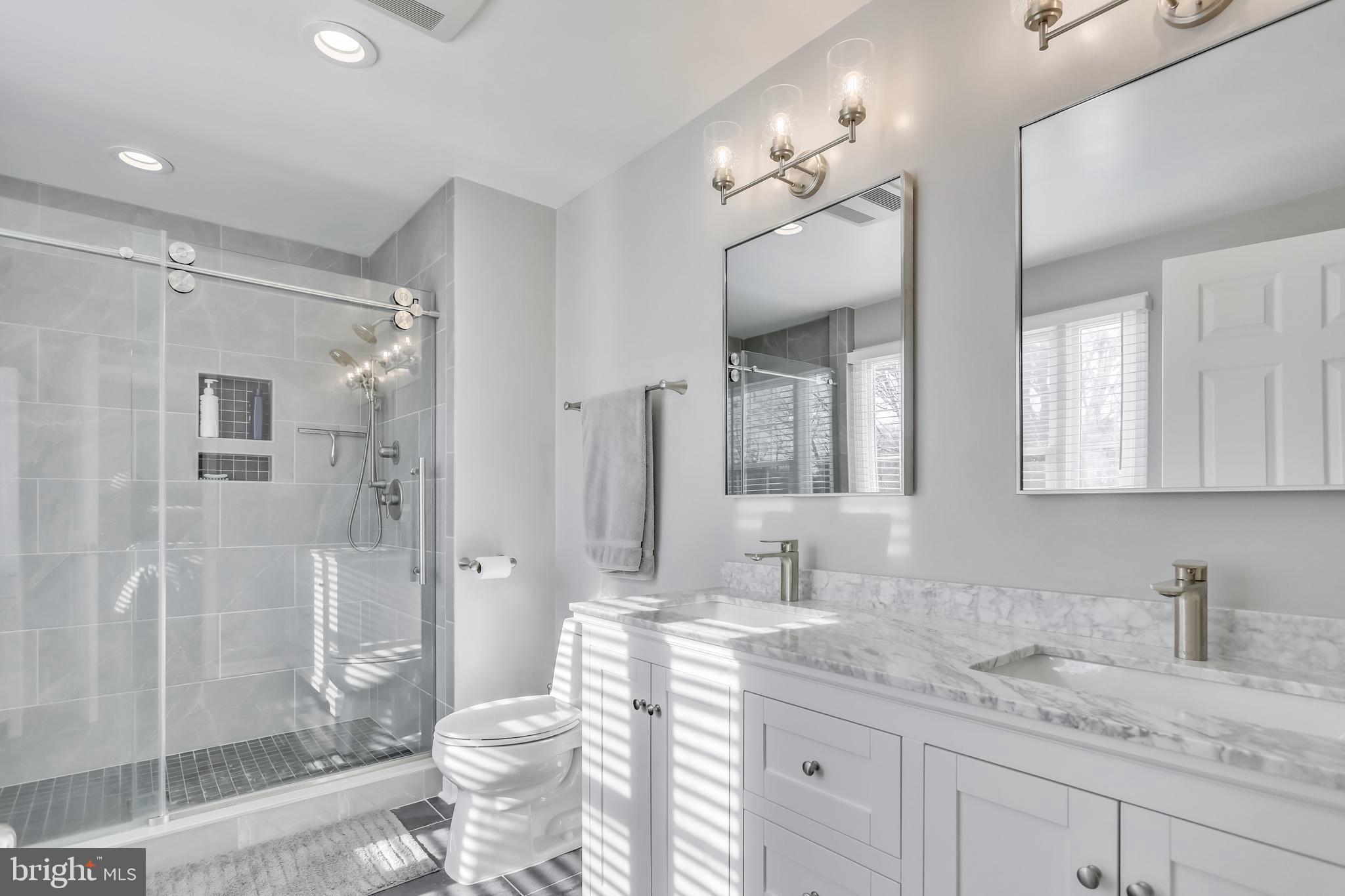 10783 Kinloch Road Silver Spring, MD 20903 - Photo 22 of 43 a bathroom with a granite countertop sink toilet and shower