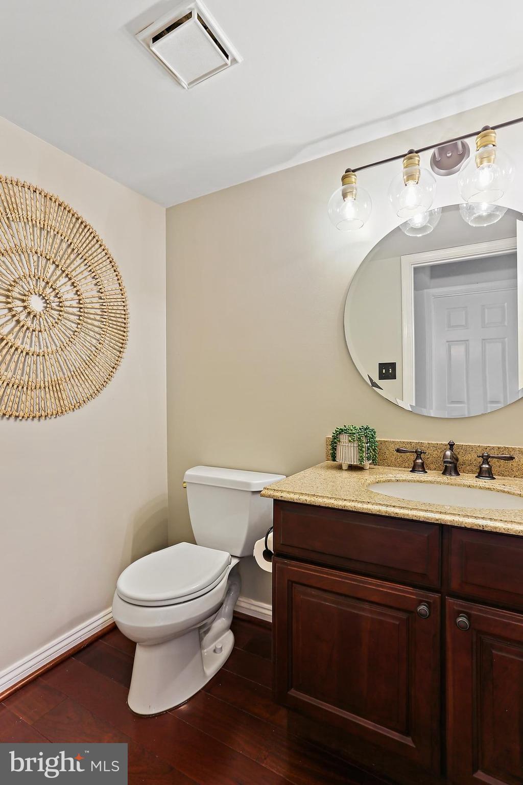 2111 Stonewall Road Baltimore, MD 21228 - Photo 24 of 58 a bathroom with a toilet a sink and mirror