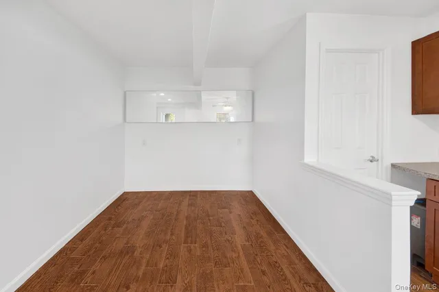 a view of a room with wooden floor