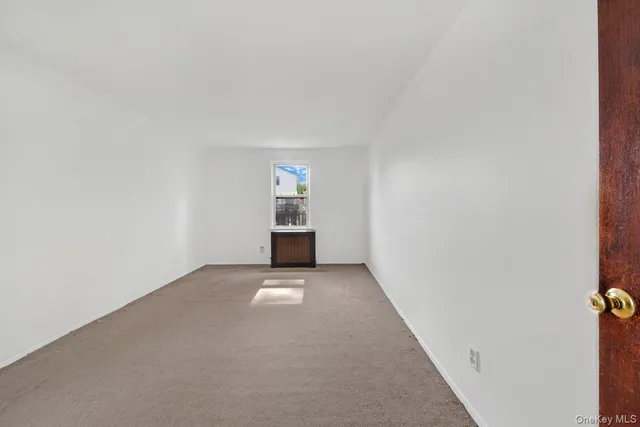 a view of an empty room with a kitchen