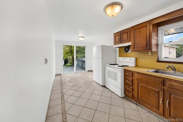 a kitchen with a stove a sink and a refrigerator