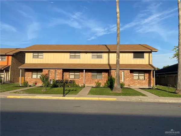 a view of building with a big yard