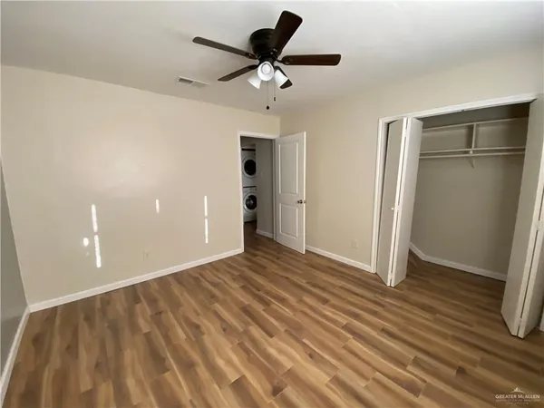 a view of an empty room and wooden floor