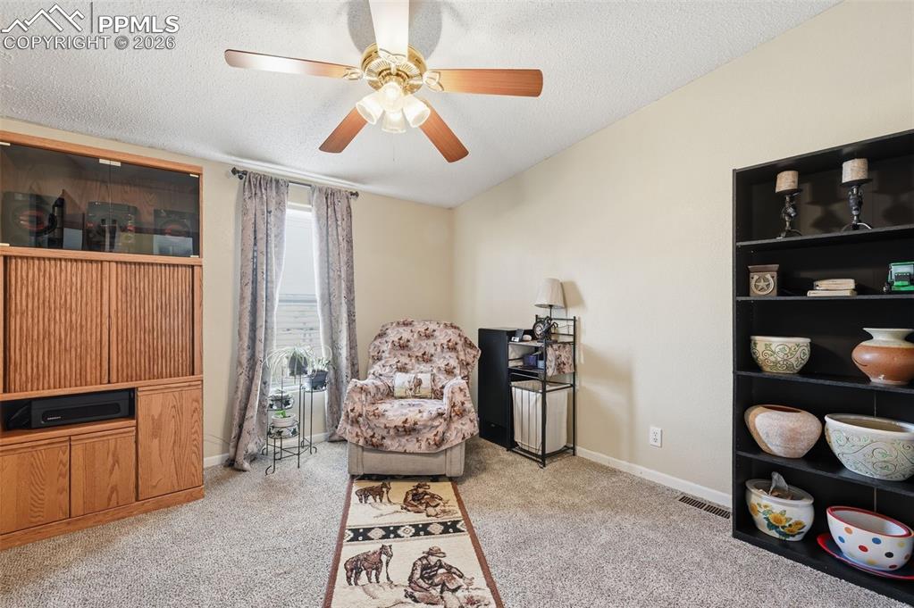 20985 McDaniels Road Calhan, CO 80808 - Photo 33 of 41 a living room with furniture and a window