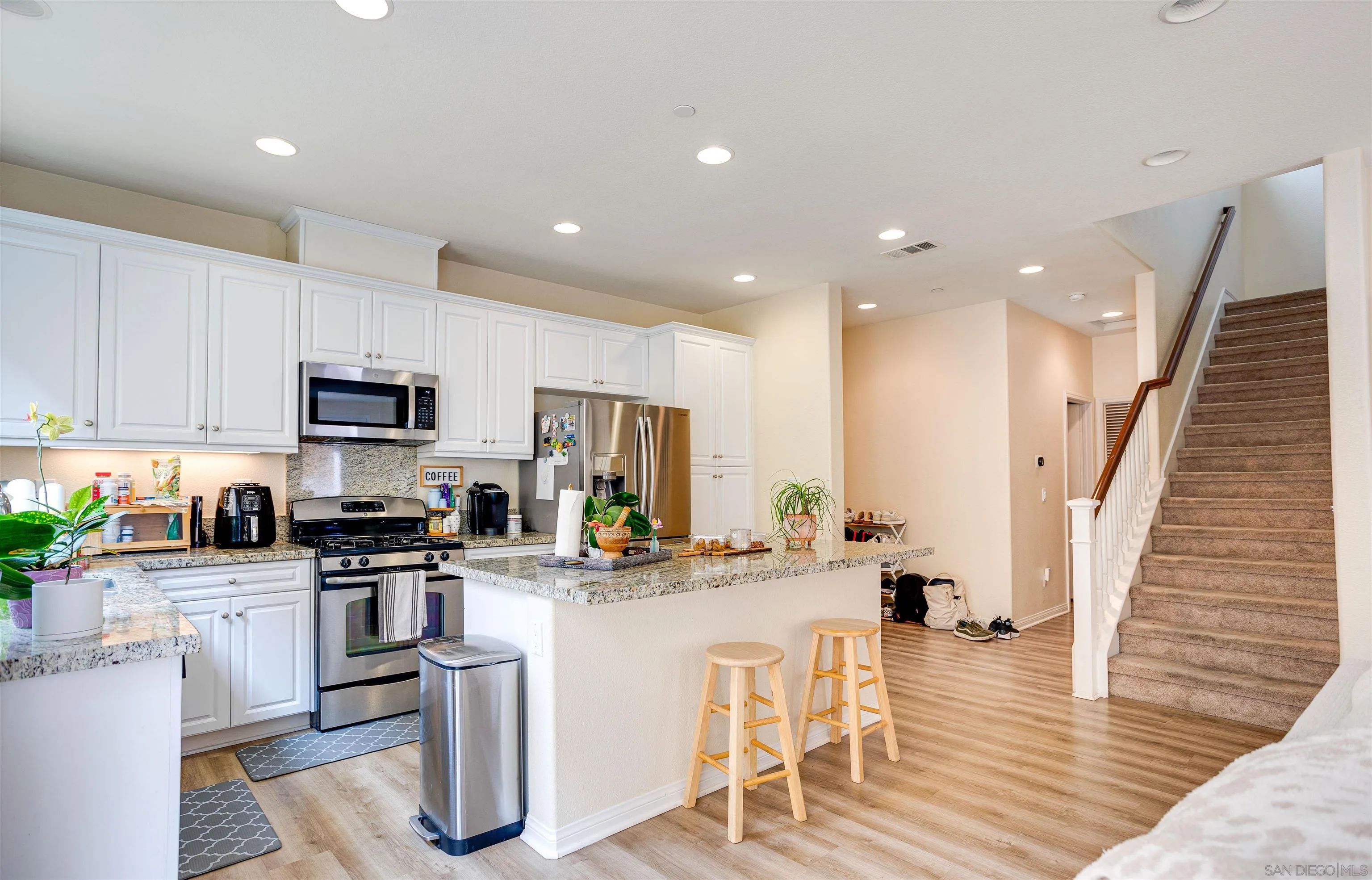 1447 Chert Drive San Marcos, CA 92078 - Photo 1 of 28 a kitchen with white cabinets and stainless steel appliances