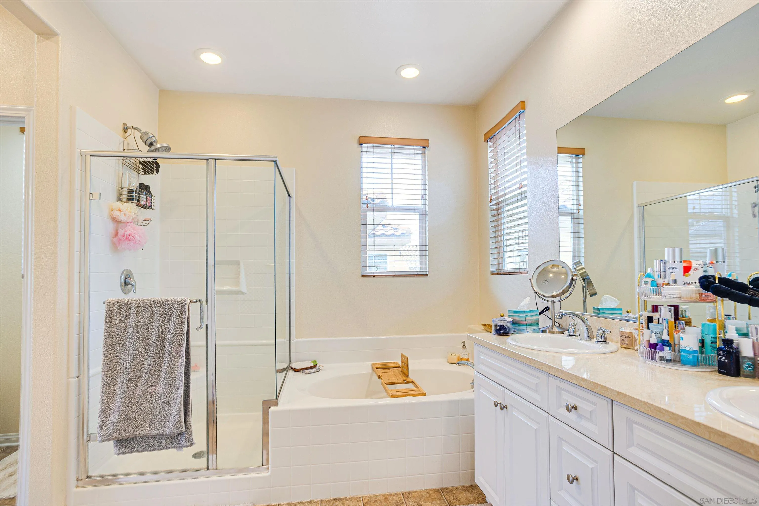 1447 Chert Drive San Marcos, CA 92078 - Photo 13 of 28 a bathroom with a tub sink and mirror