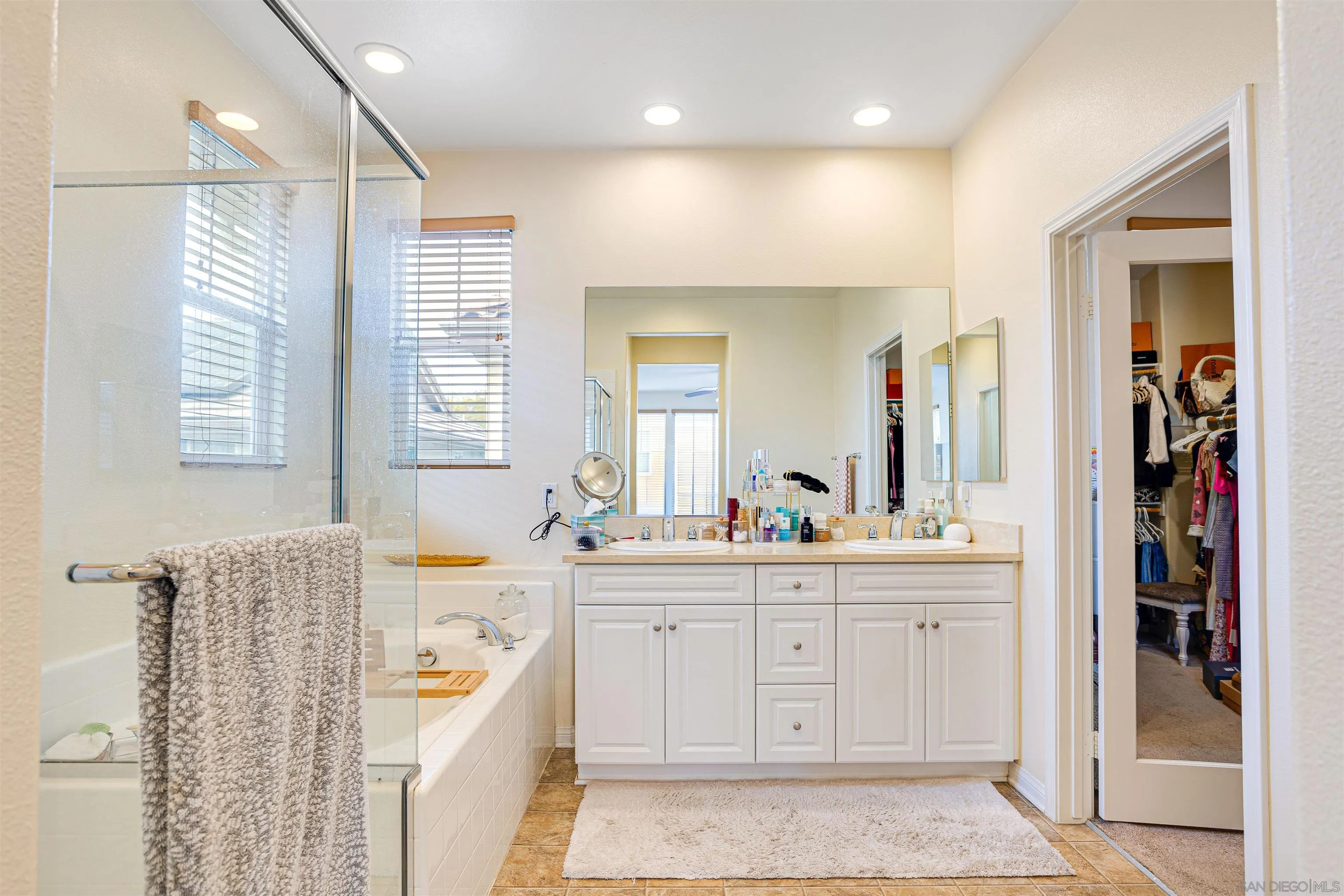 1447 Chert Drive San Marcos, CA 92078 - Photo 14 of 28 a large bathroom with a double vanity sink a mirror and a bathtub