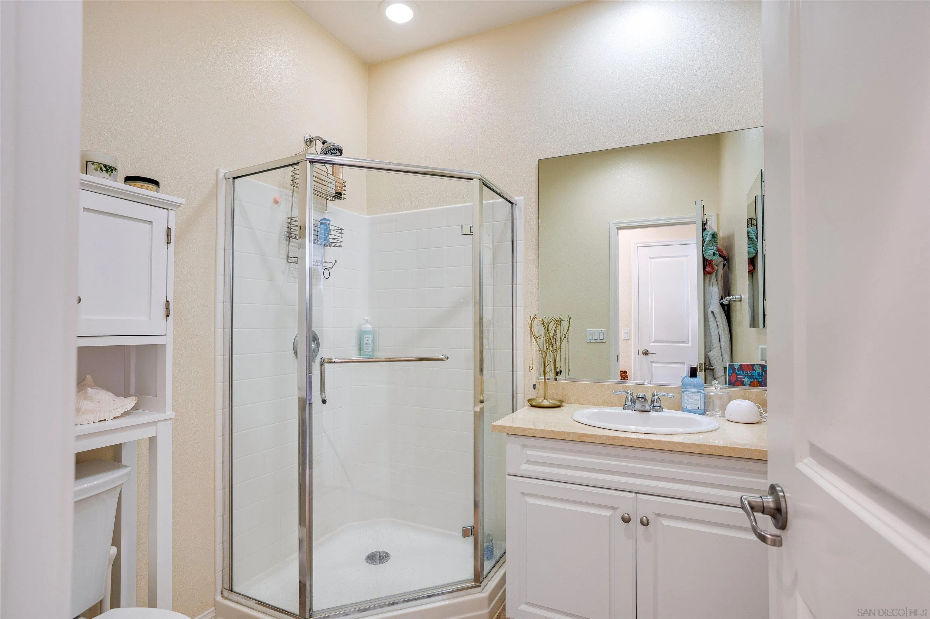 1447 Chert Drive San Marcos, CA 92078 - Photo 16 of 28 a bathroom with a shower sink and mirror