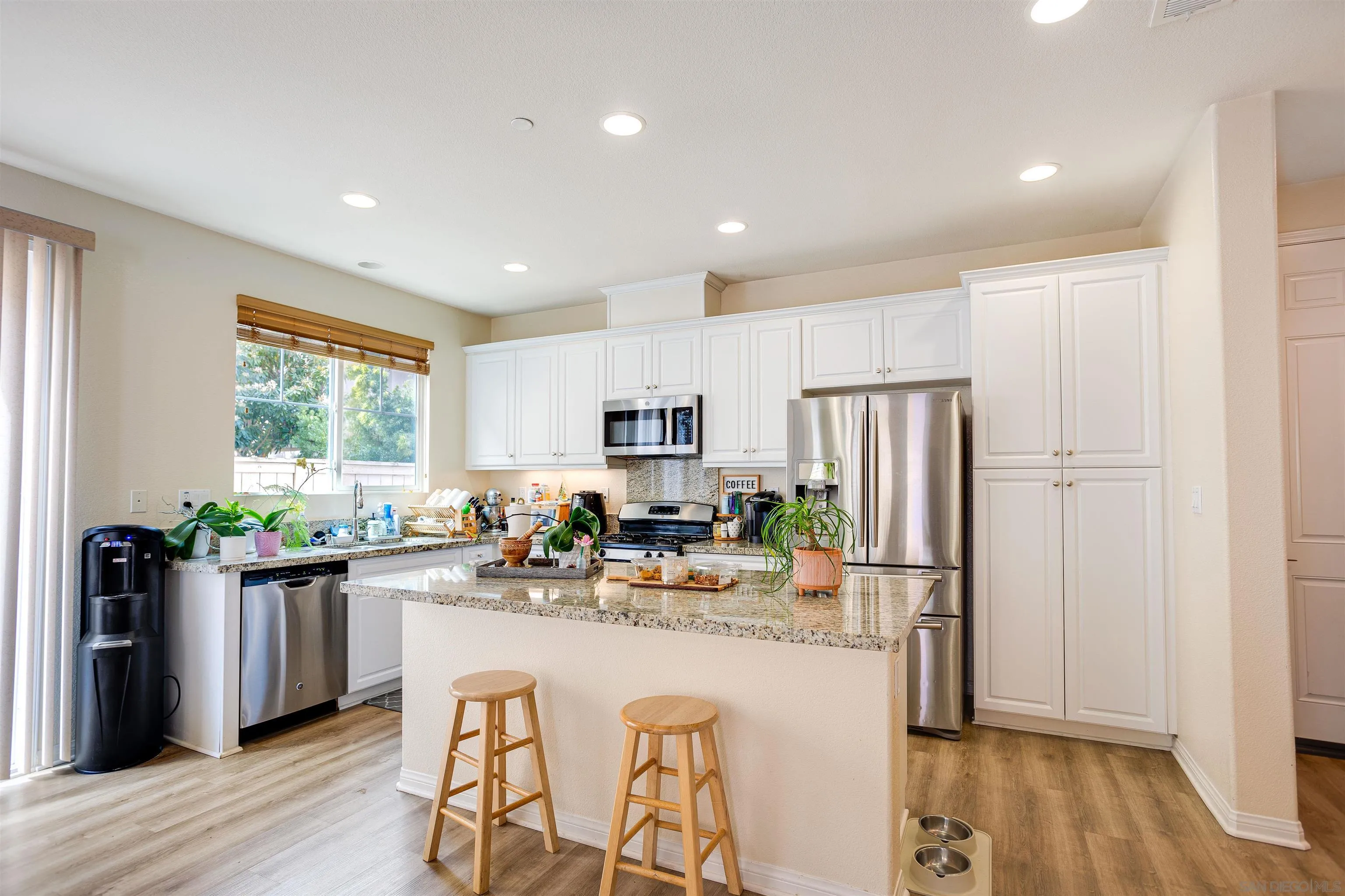 1447 Chert Drive San Marcos, CA 92078 - Photo 2 of 28 a kitchen with stainless steel appliances kitchen island granite countertop a refrigerator and microwave