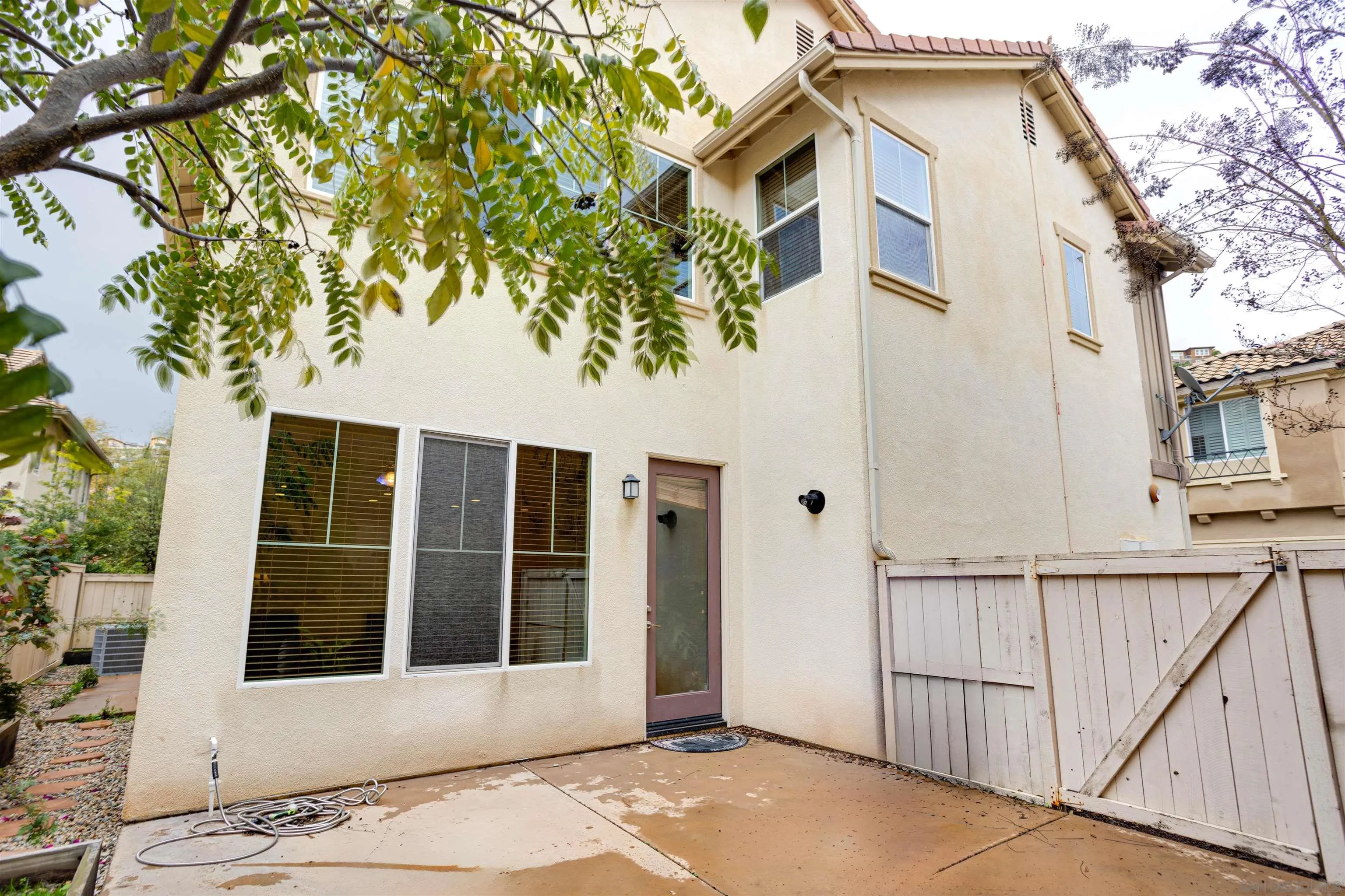 1447 Chert Drive San Marcos, CA 92078 - Photo 21 of 28 a front view of a house with a tree
