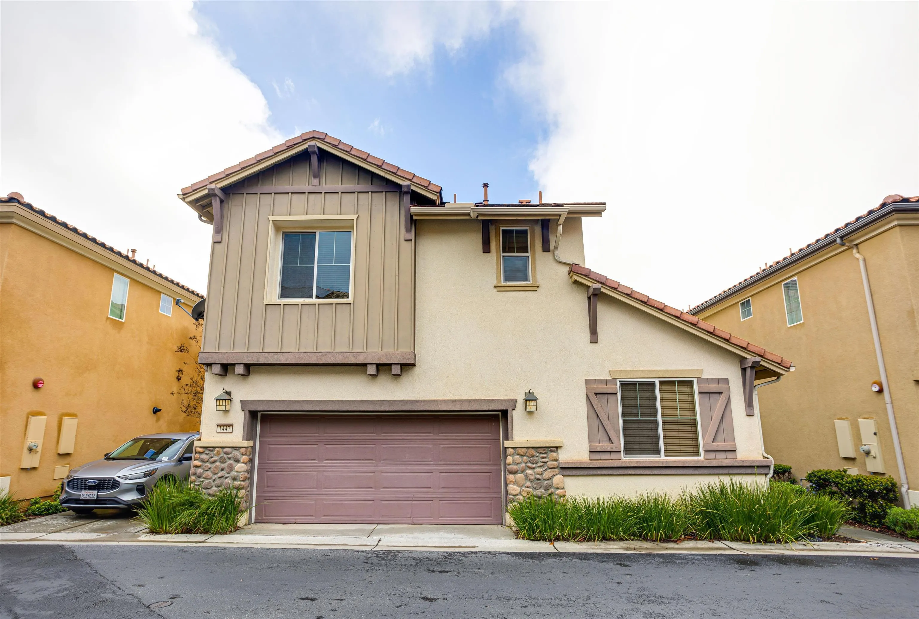 1447 Chert Drive San Marcos, CA 92078 - Photo 25 of 28 a front view of a house with a yard and garage