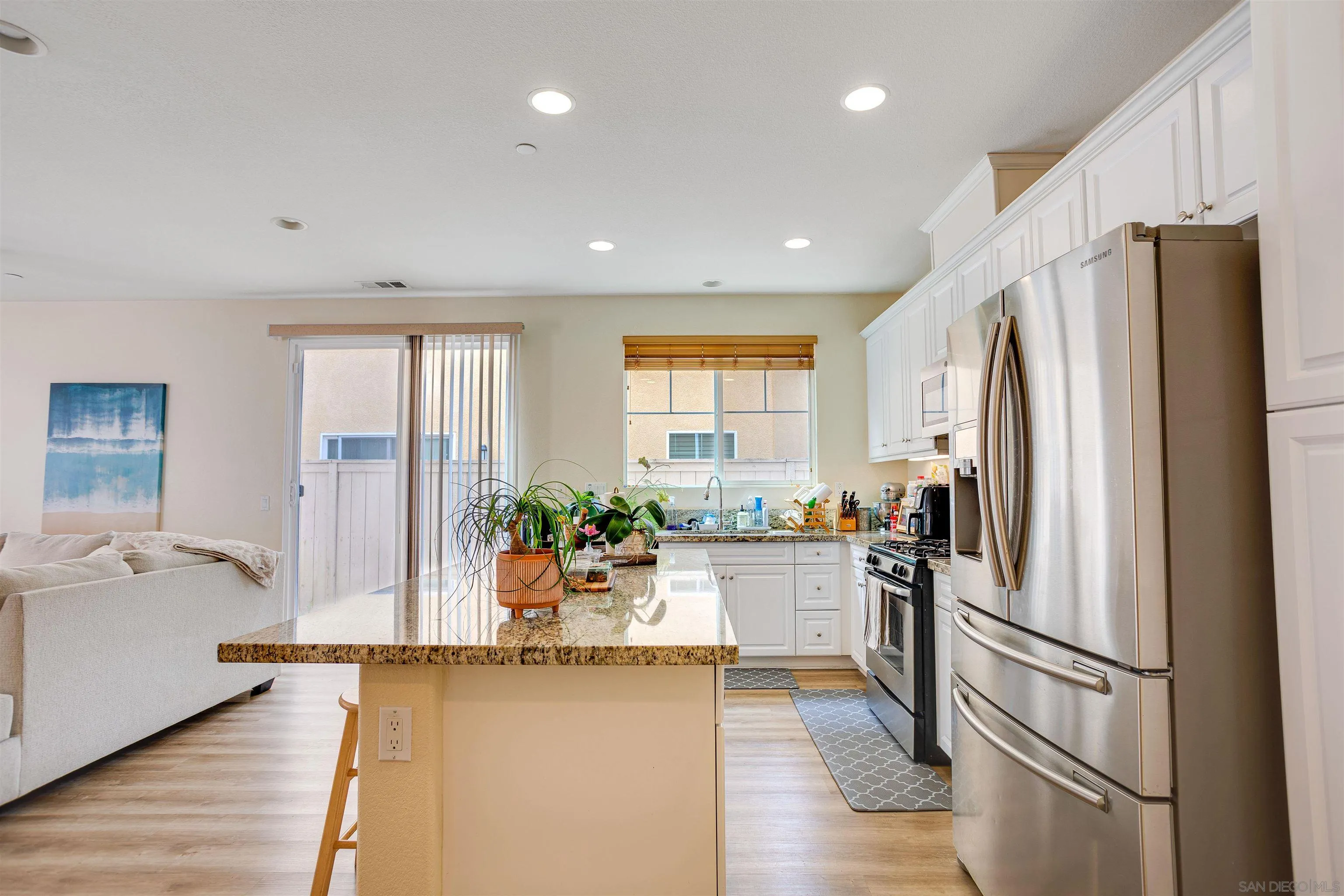 1447 Chert Drive San Marcos, CA 92078 - Photo 3 of 28 a kitchen with a refrigerator and a sink