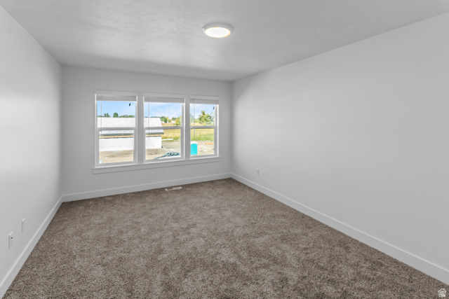 2995 South 265th Street West, Unit 752 Logan, UT 84321 - Photo 16 of 21 Room featuring plush grey carpeting, white painted walls, and bright white baseboards