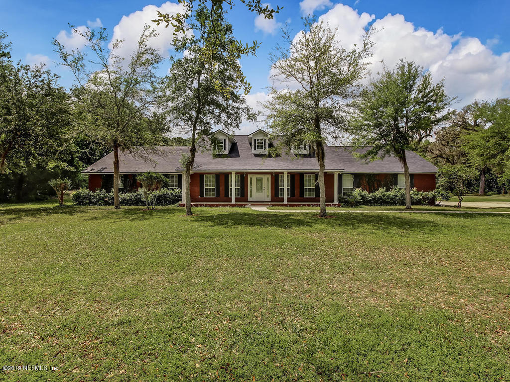 86051 Ellis Estates Landing Road Yulee, FL 32097 - Photo 1 of 35 a front view of a house with a yard