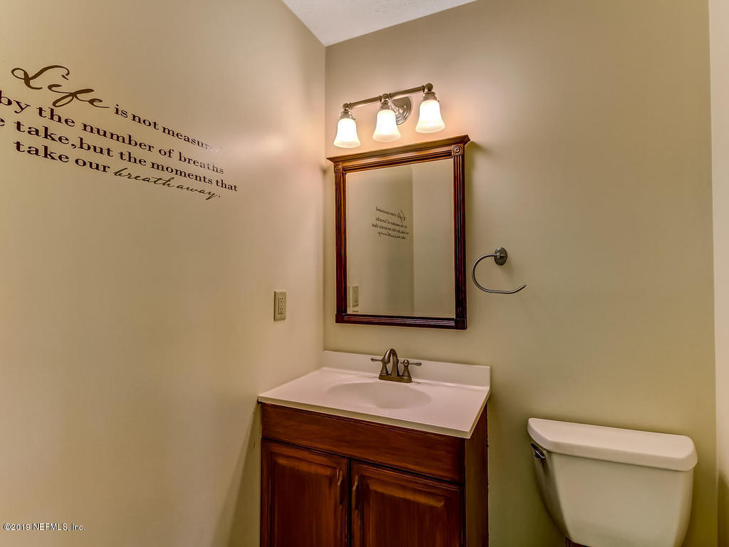 86051 Ellis Estates Landing Road Yulee, FL 32097 - Photo 11 of 35 a bathroom with a toilet a sink and mirror