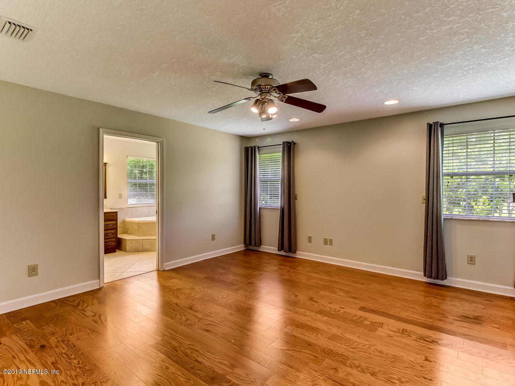 86051 Ellis Estates Landing Road Yulee, FL 32097 - Photo 13 of 35 a view of an empty room with window and wooden floor
