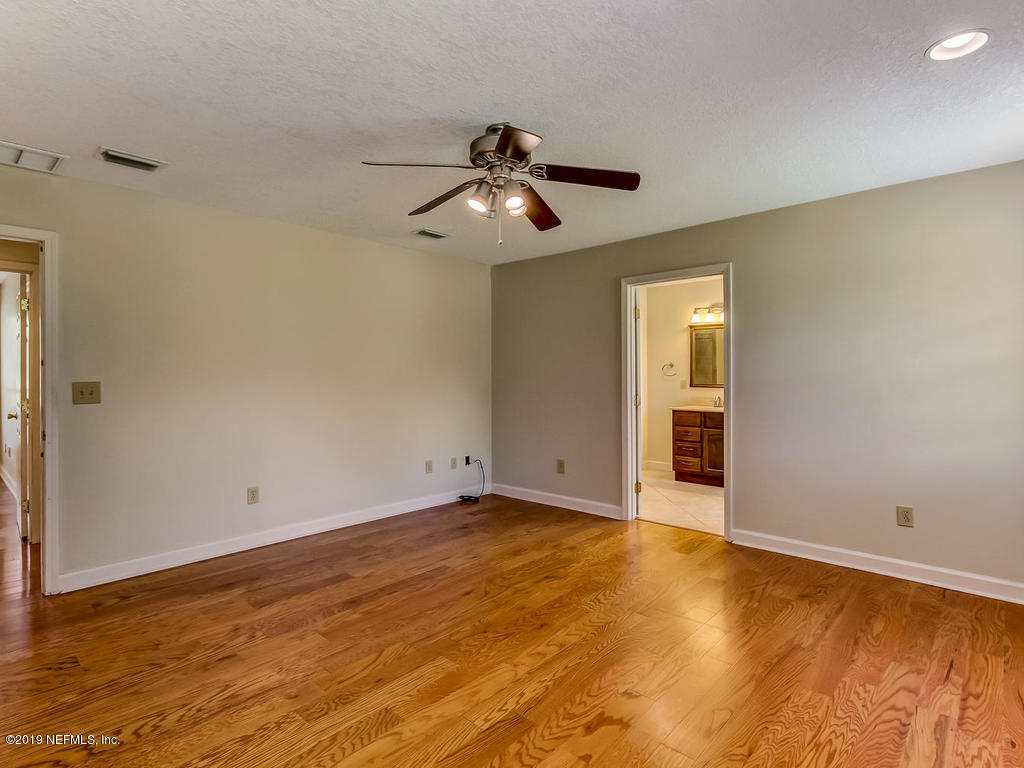 86051 Ellis Estates Landing Road Yulee, FL 32097 - Photo 14 of 35 a view of an empty room with window and chandelier fan