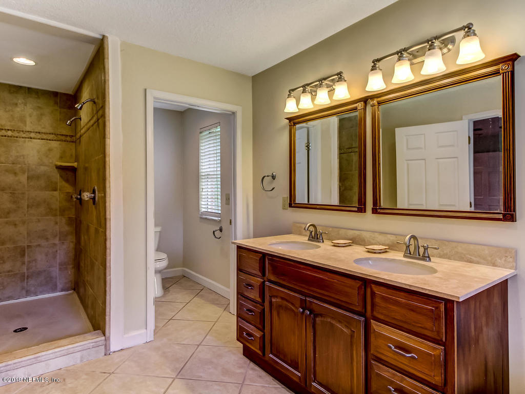 86051 Ellis Estates Landing Road Yulee, FL 32097 - Photo 16 of 35 a bathroom with a sink and a mirror
