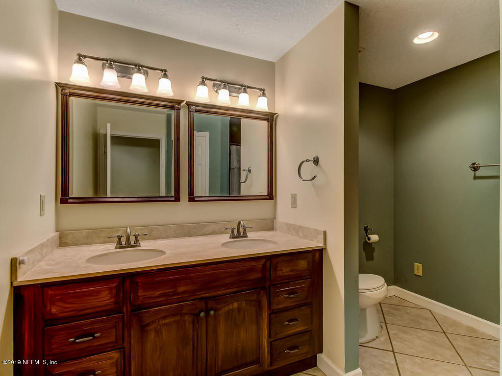 86051 Ellis Estates Landing Road Yulee, FL 32097 - Photo 19 of 35 a bathroom with a double vanity sink and a mirror