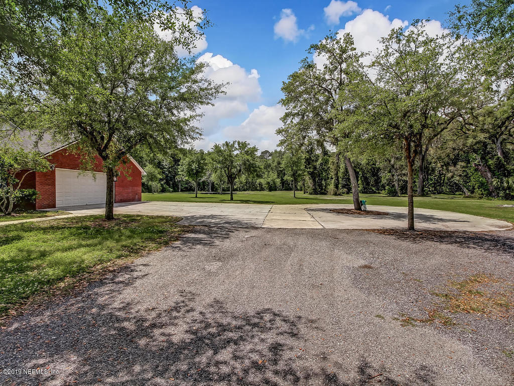 86051 Ellis Estates Landing Road Yulee, FL 32097 - Photo 22 of 35 a view of a yard with basketball court