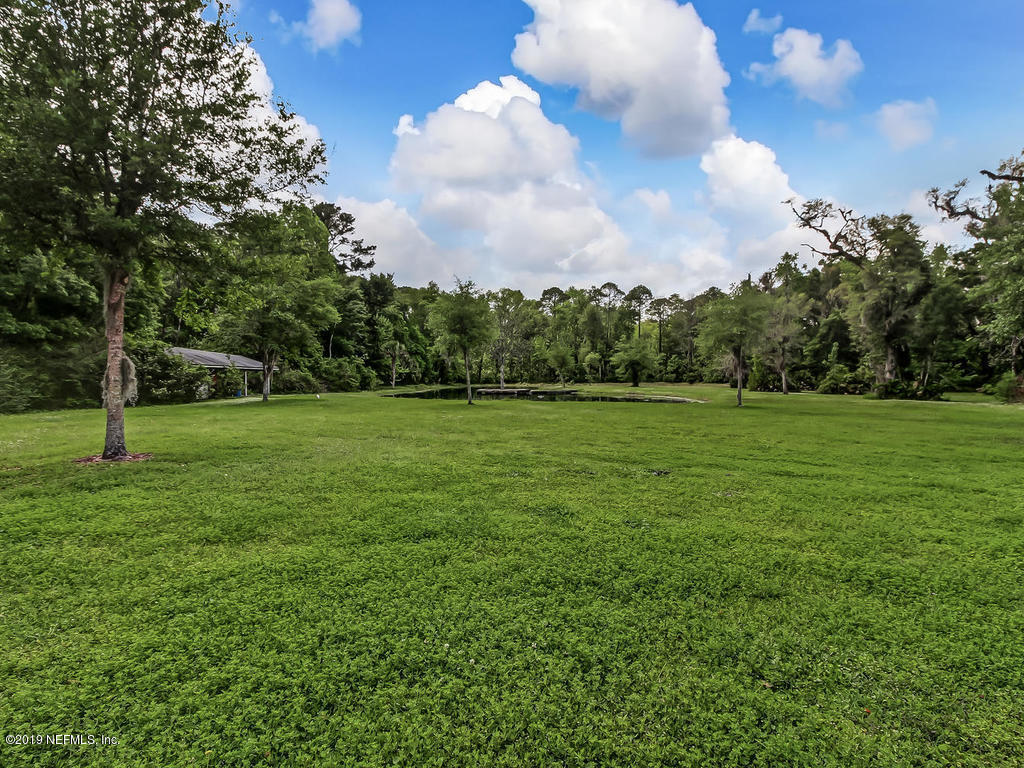 86051 Ellis Estates Landing Road Yulee, FL 32097 - Photo 24 of 35 a backyard of a house with lots of green space