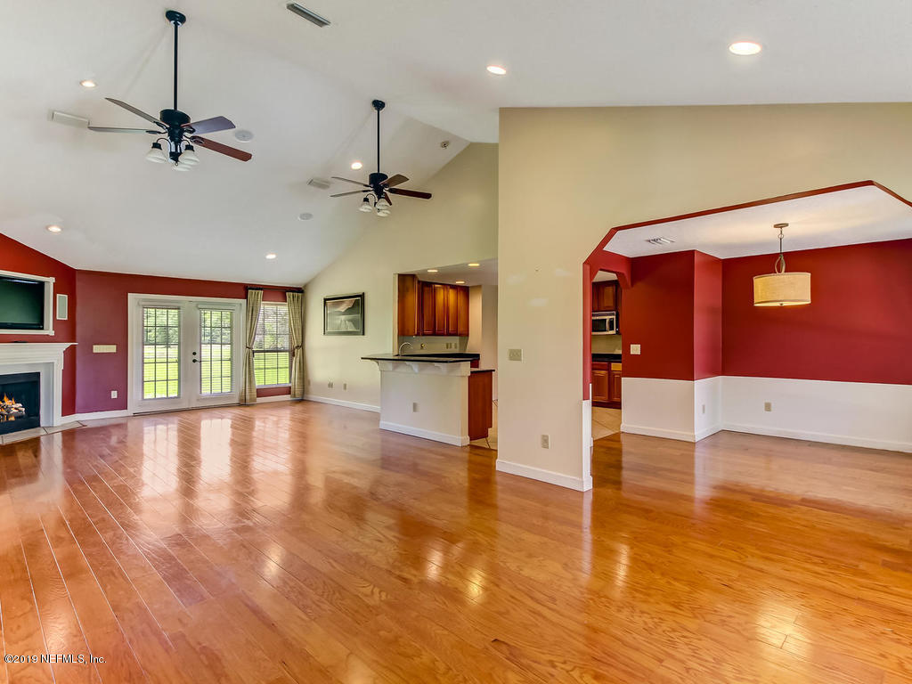 86051 Ellis Estates Landing Road Yulee, FL 32097 - Photo 3 of 35 a view of empty room with wooden floor and fan
