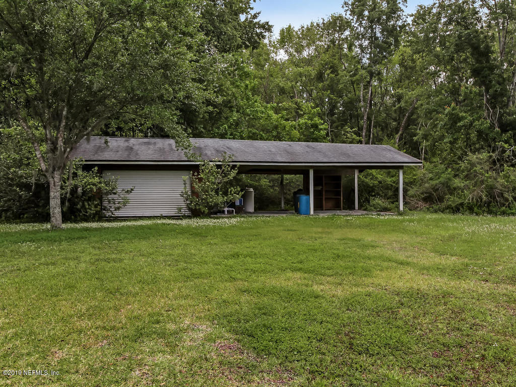 86051 Ellis Estates Landing Road Yulee, FL 32097 - Photo 31 of 35 a front view of a house with a garden